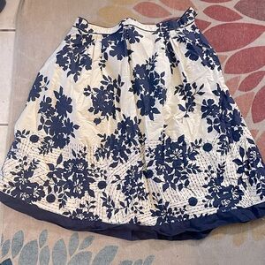Cream and navy blue colored a line skirt with floral and stitching pattern